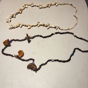 A pair of handmade necklaces;a seashell necklace & tribal styled necklace.